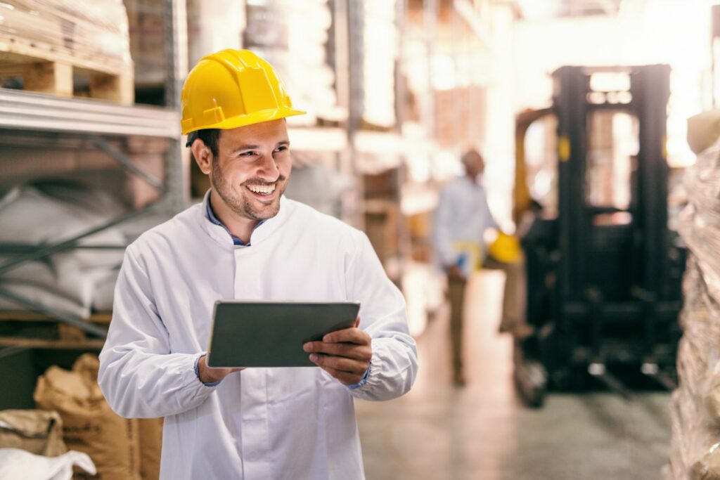 man in a warehouse holding a tablet