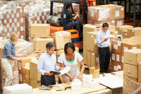 people standing in front of an assembly line