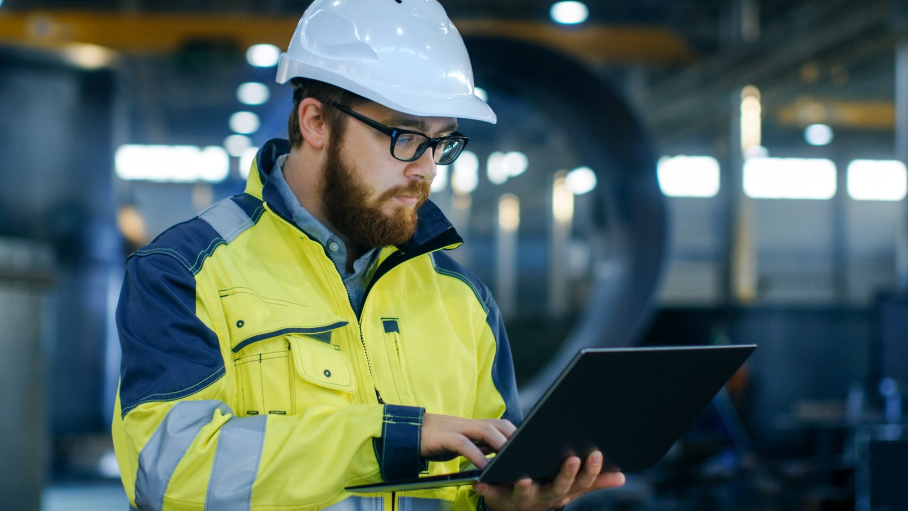 guy with hardhat looking at his computer